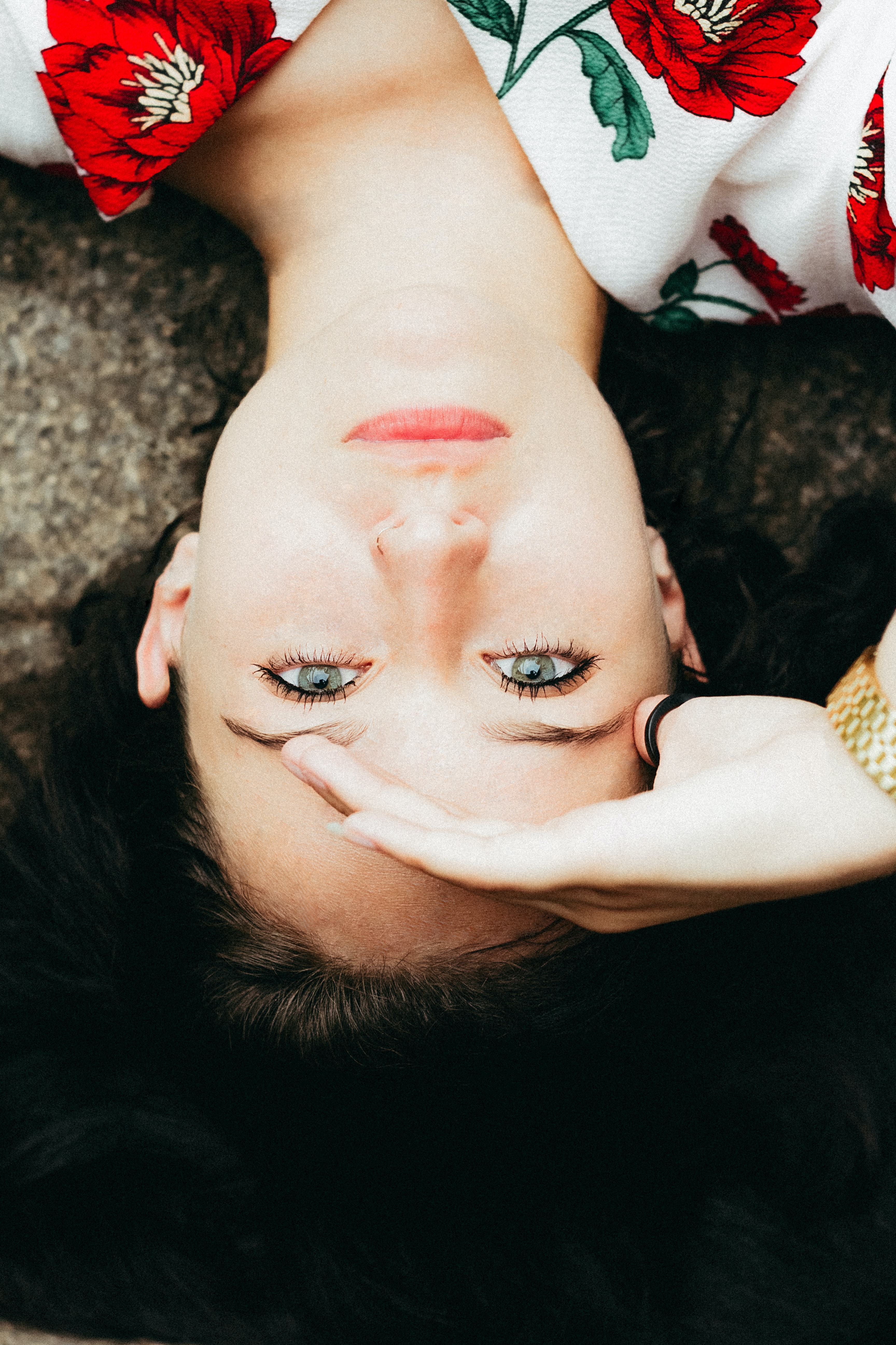 woman wearing makeup and red flower top