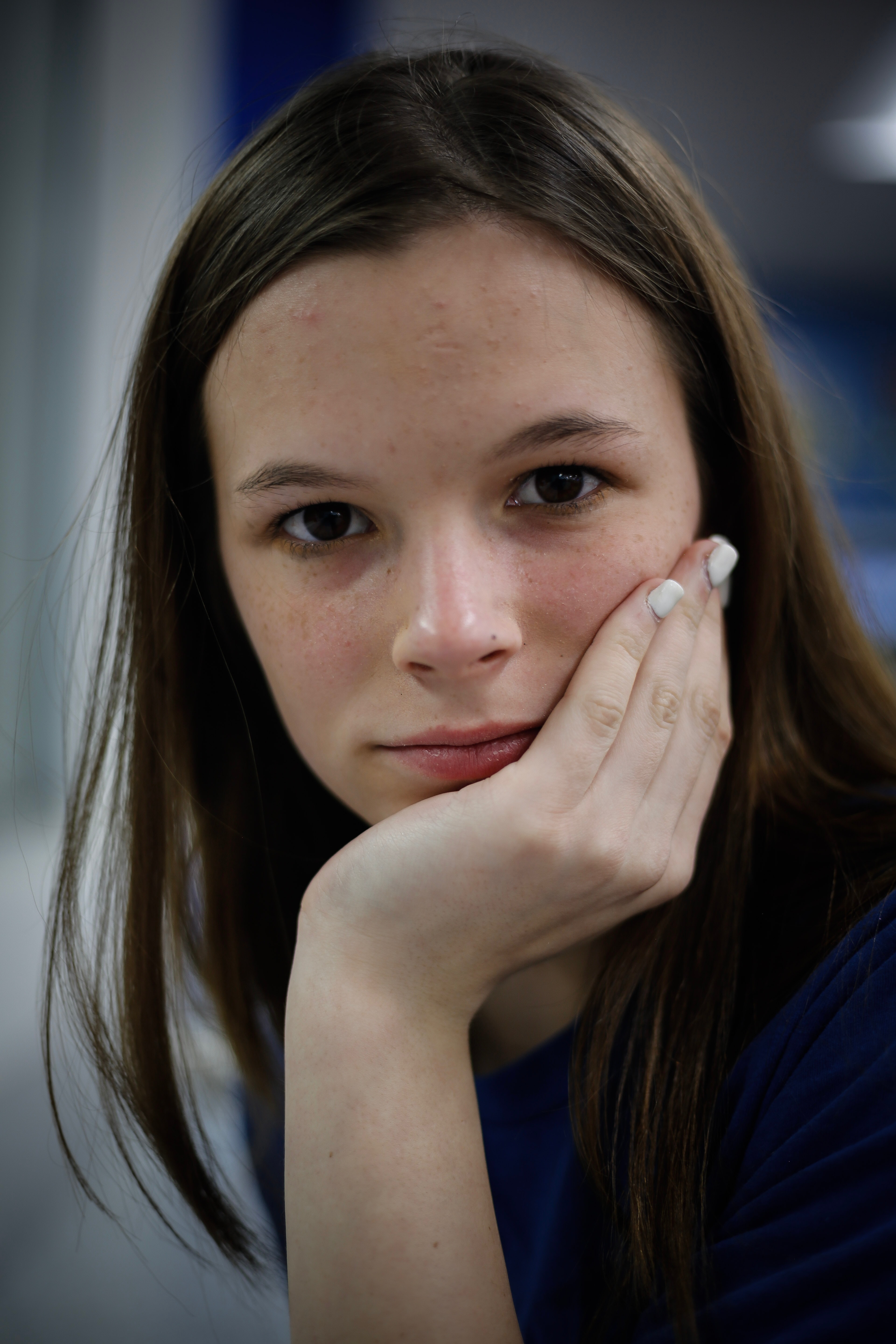 girl holding face in hand